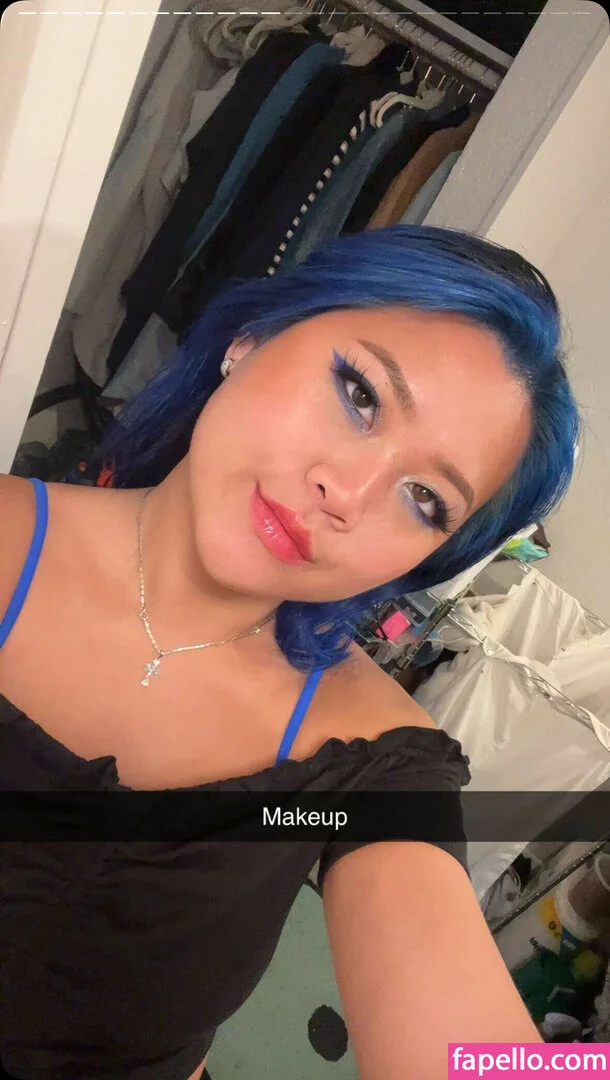 Lola Bootyluv in cowboy boots straddling a motorcycle