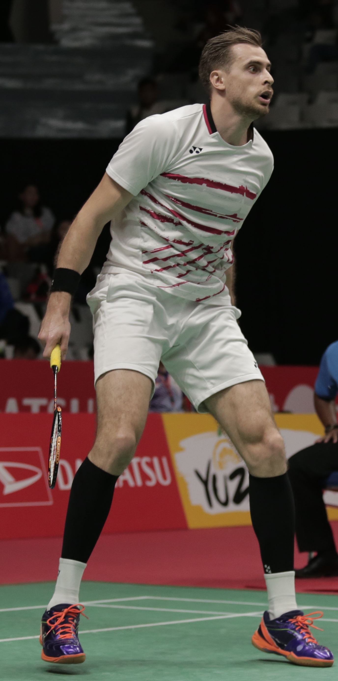 Andrey Ashmarin focused during badminton doubles match