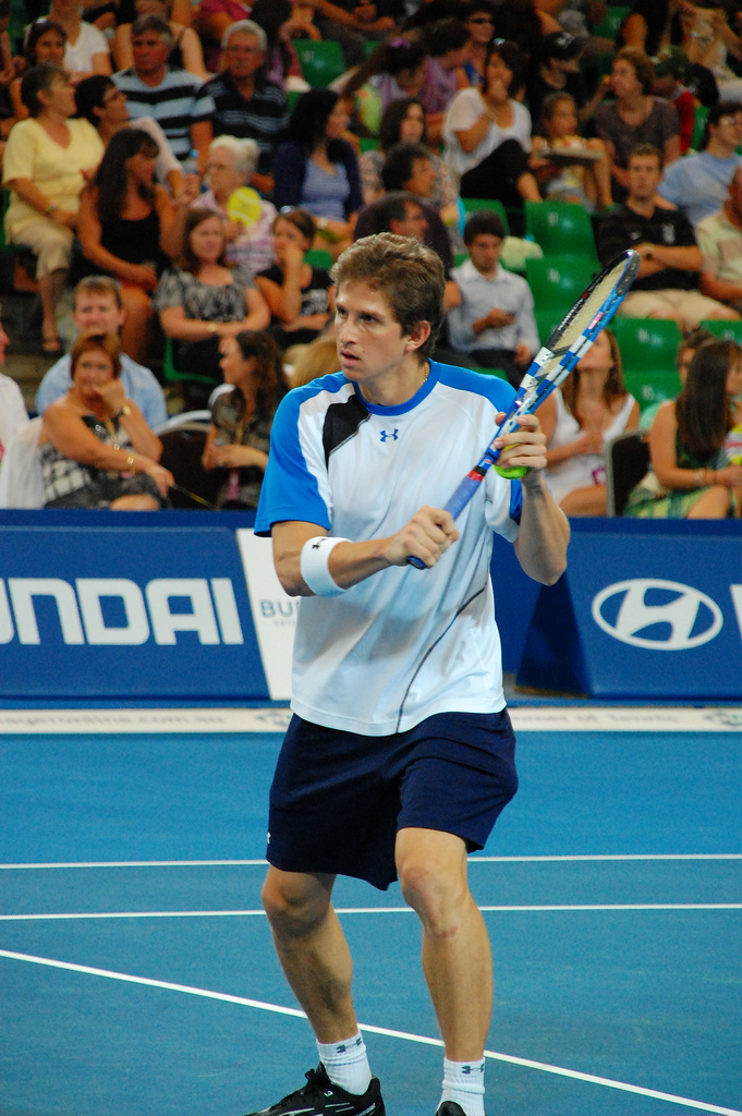 Igor Andreev serving on clay court during ATP match